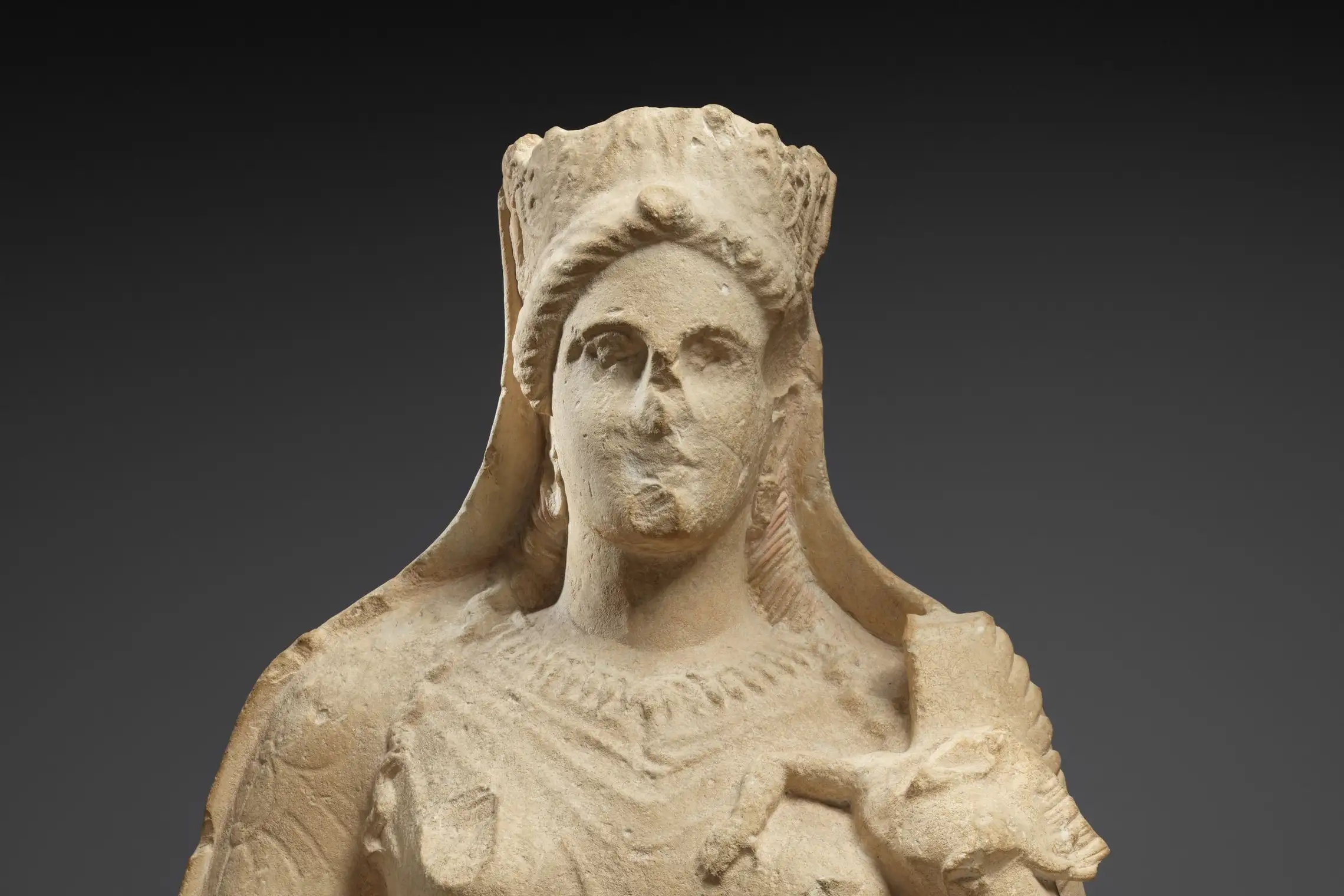 Cropped - Limestone statue of Aphrodite holding winged Eros